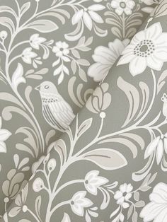 an upholstered wallpaper with white flowers and birds on grey background, closeup