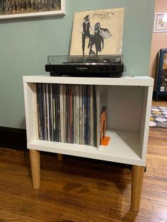 a record player sitting on top of a white shelf