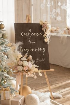 a sign that says welcome to our wedding next to a christmas tree with presents on it