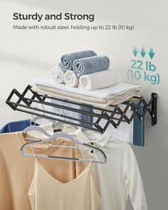 there is a rack with towels and folded clothes on it, along with other items