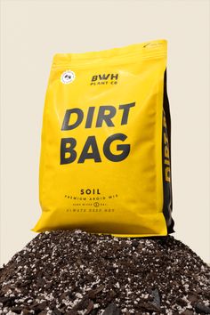 a bag of dirt sitting on top of a pile of rocks