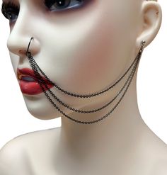 a mannequin head with chains and piercings on it's nose is shown