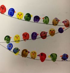 the colorful birds are sitting on the wire