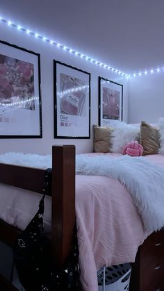 a bed room with a neatly made bed and two pictures on the wall above it