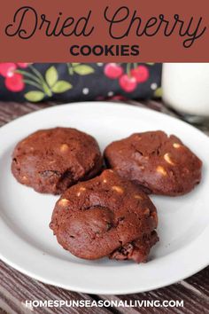 three chocolate cookies on a white plate next to a glass of milk with text overlay