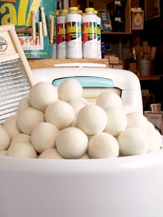 a large bowl filled with lots of white balls next to a pile of other items