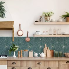 a kitchen counter with pots and pans on top of it next to a shelf