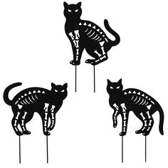 three black cats sitting on top of each other in the shape of skeleton bones and skeletons