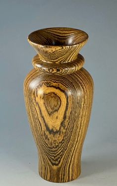 a wooden vase sitting on top of a table