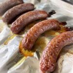 some sausages are laying on top of foil