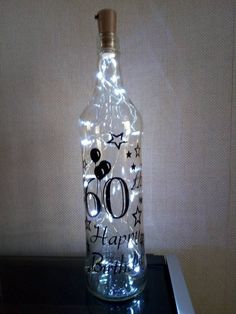 a bottle that is sitting on a table with some lights in the top and bottom