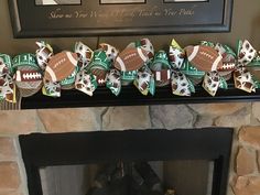 a fireplace mantel decorated with paper footballs and other sports themed decorations on it