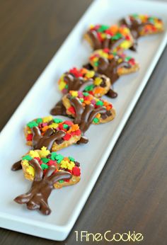 there is a white plate that has some cookies on it and chocolate chips in the shape of trees