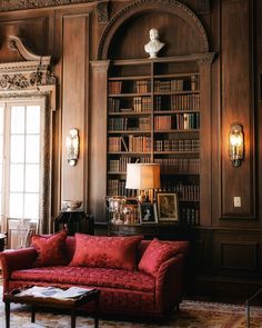 a living room filled with furniture and bookshelves