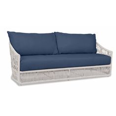 a white wicker couch with blue cushions