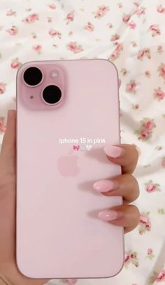 a woman's hand holding an iphone 11 in pink