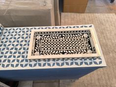 a blue and white table with an intricate design on it