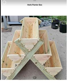 some wooden boxes are stacked on top of each other in order to be used as planters