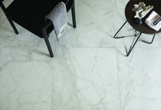 a chair and table in a room with white marble flooring