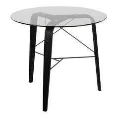 a round glass table with black legs