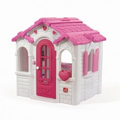 a pink and white play house with windows