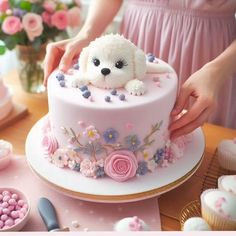 a woman is decorating a pink cake with flowers and a dog on the top