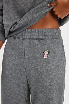 These simple sweatpants from For Love & Lemons are featured in a soft French terry fabrication and finished with an embroidered rose for a sweet touch. **Fit:** Mid-rise, relaxed **Features:** French terry fabrication, elastic waistband, cinched cuffs, side pockets, embroidered rose motif **Why We | For Love & Lemons Julie Sweatpants at Free People in Grey, Size: S Relaxed Fit Sweats With Embroidered Logo And Long Sleeves, Sporty Sweat-resistant Elastane Bottoms, Long Sleeve Fleece Sweats With Embroidered Logo, Relaxed Fit Fleece Sweats With Embroidered Logo, For Love And Lemons Sweater, For Love & Lemons, Womens Sweatpants, Pink Sand, Fashion Joggers