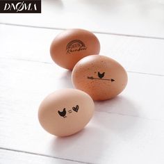 three eggs with faces drawn on them sitting next to each other