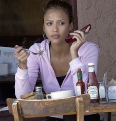 a woman sitting at a table eating food