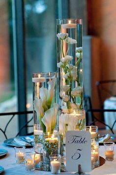 the centerpieces are filled with candles and flowers