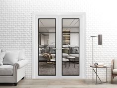 a living room with white brick walls and glass doors that lead into the dining area