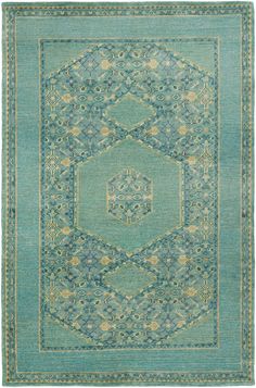 a green rug with an intricate design in the middle