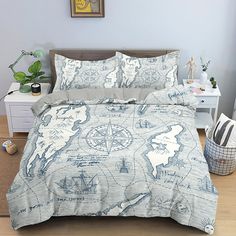 a bed covered in a blue and white comforter next to a nightstand with a potted plant