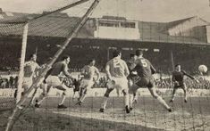 an old black and white photo of men playing soccer