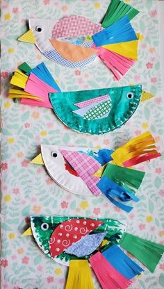 three colorful birds made out of construction paper