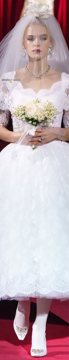 a woman in a white wedding dress and veil