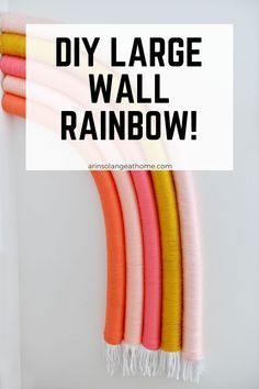 the diy large wall rainbow is hanging on a wall