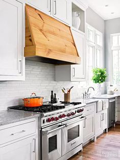 a kitchen with white cabinets and an oven