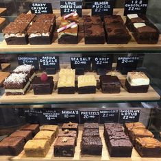 a display case filled with lots of different types of cakes