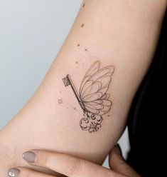 a woman's arm with a butterfly tattoo on it and a toothbrush in the middle