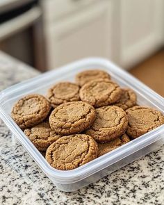 a plastic container filled with cookies on top of a counter