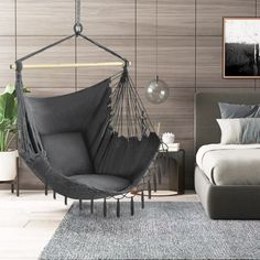 a bedroom with a bed and a hammock chair