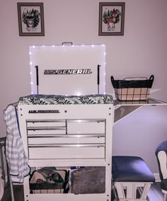 a white dresser sitting next to a blue chair