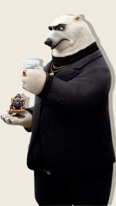 a polar bear dressed in black holding a cup