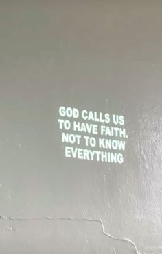 there is a message written on the back of a laptop screen that says god calls us to have faith, not to know everything