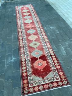 a long red rug is on the ground