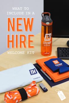 an orange and black water bottle sitting on top of a desk next to a computer