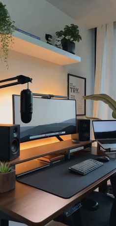 a computer desk with two monitors and speakers