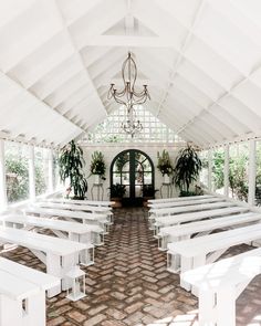 the inside of a church with white benches