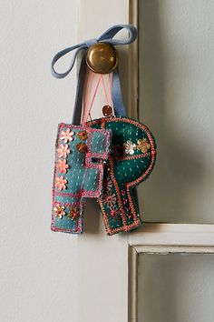 an elephant ornament hanging from the side of a door